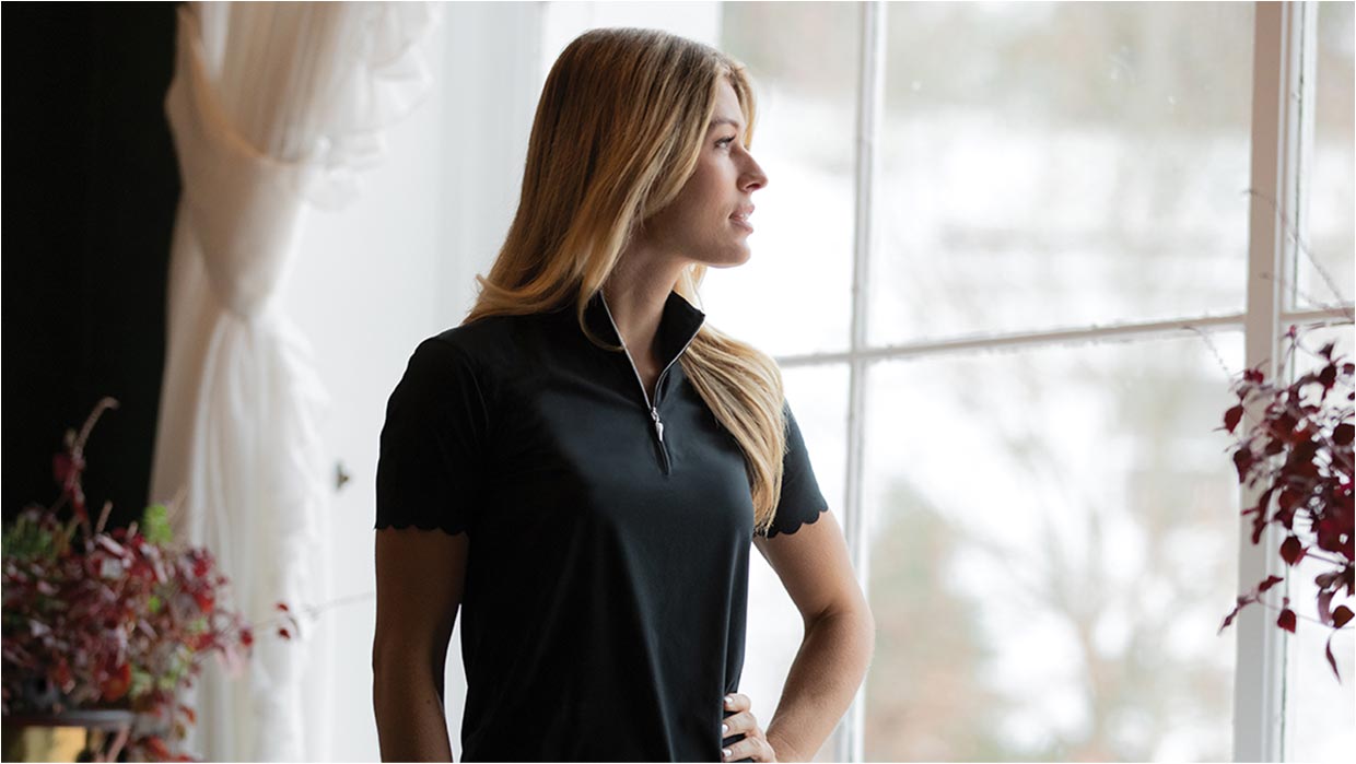 blonde woman with greg norman shirt